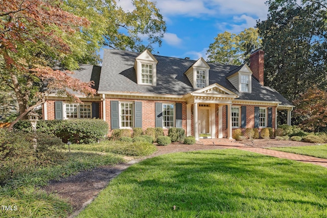 new england style home featuring a front lawn