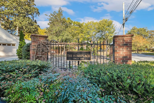 community sign featuring a garage