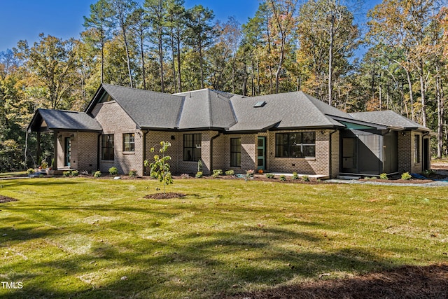 1414 Whippoorwill Ln, Chapel Hill, NC 27517 - view of front facade featuring brick siding, a front yard, and a shingled roof