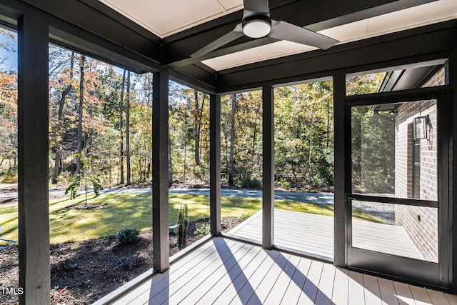 unfurnished sunroom with ceiling fan