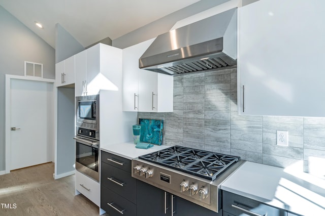 1414 Whippoorwill Ln, Chapel Hill, NC 27517 - kitchen with appliances with stainless steel finishes, wall chimney range hood, decorative backsplash, light countertops, and white cabinets