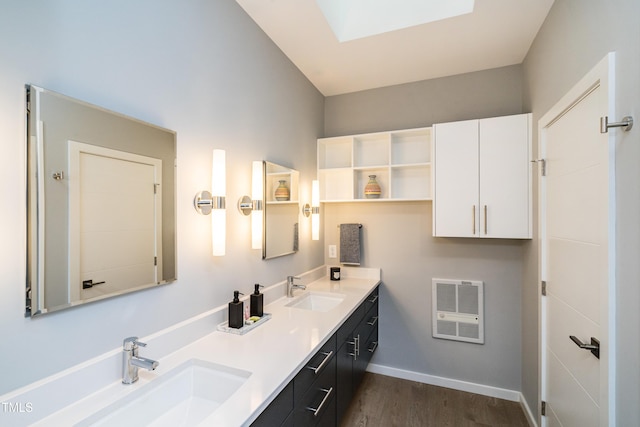 1414 Whippoorwill Ln, Chapel Hill, NC 27517 - full bathroom with wood finished floors, heating unit, double vanity, and baseboards