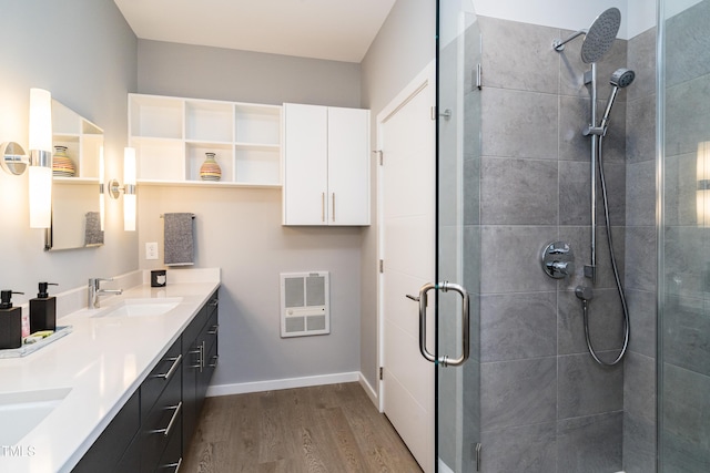 1414 Whippoorwill Ln, Chapel Hill, NC 27517 - full bathroom with wood finished floors, a stall shower, heating unit, double vanity, and baseboards