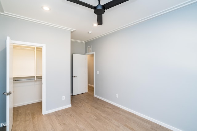 unfurnished bedroom with ceiling fan, a closet, light hardwood / wood-style flooring, and crown molding