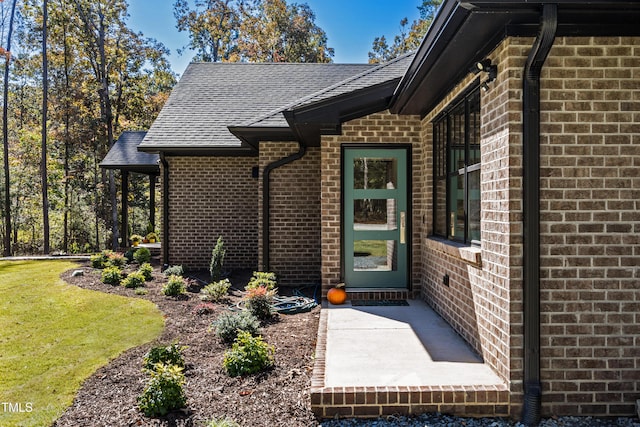 1414 Whippoorwill Ln, Chapel Hill, NC 27517 - property entrance with brick siding, roof with shingles, and a lawn