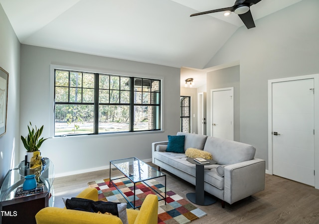 living room with high vaulted ceiling, ceiling fan, and dark hardwood / wood-style floors