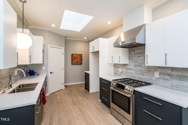 1414 Whippoorwill Ln, Chapel Hill, NC 27517 - kitchen with gas stove, a sink, wall chimney exhaust hood, a skylight, and tasteful backsplash