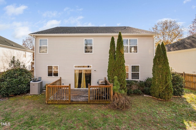 back of house with a lawn, a wooden deck, and central AC unit