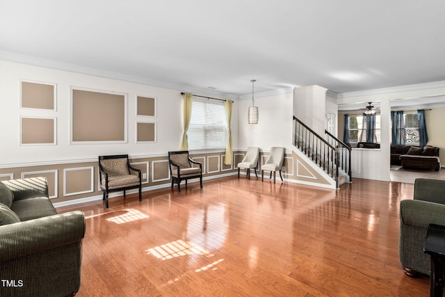 living room with crown molding and hardwood / wood-style flooring