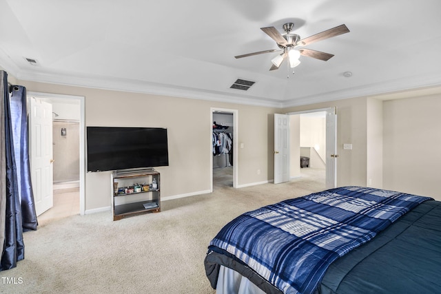 carpeted bedroom featuring ceiling fan, a closet, a spacious closet, and ornamental molding