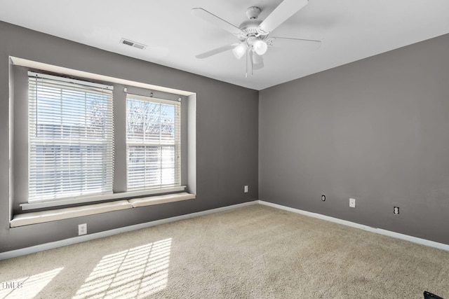 spare room with carpet flooring and ceiling fan