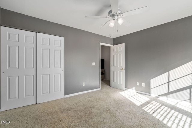 unfurnished bedroom with light carpet, a closet, and ceiling fan