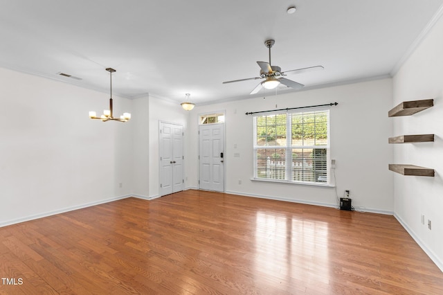 unfurnished living room featuring ornamental molding, light wood-type flooring, and ceiling fan with notable chandelier