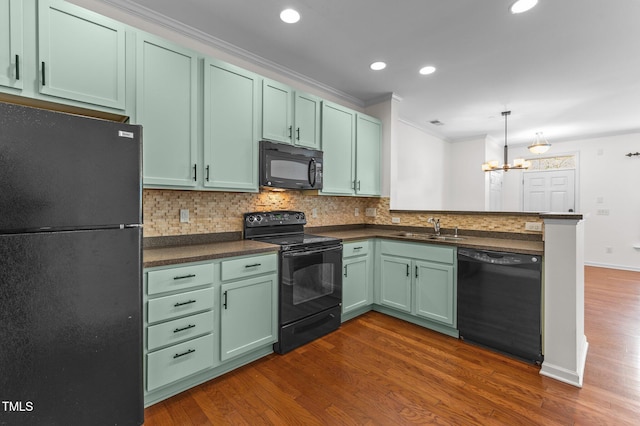 kitchen with sink, black appliances, kitchen peninsula, and dark wood-type flooring