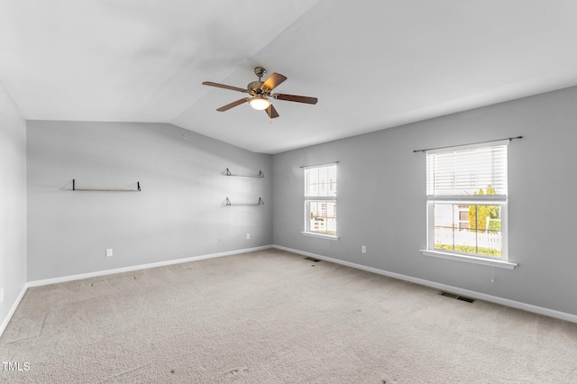 carpeted empty room with lofted ceiling and ceiling fan