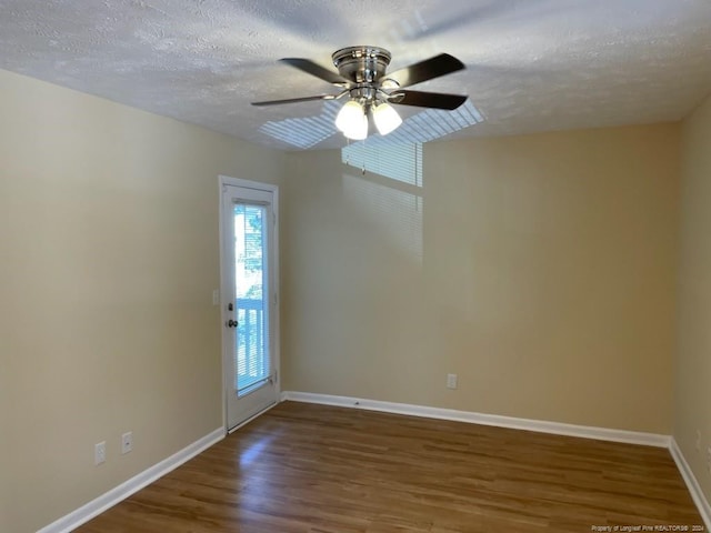 unfurnished room featuring dark hardwood / wood-style flooring, a textured ceiling, and ceiling fan