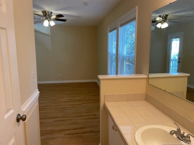 bathroom with vanity, hardwood / wood-style floors, and ceiling fan