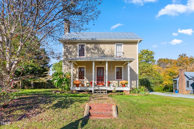 view of front facade featuring a front yard and covered porch