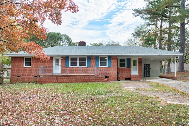 ranch-style house with a front lawn, covered porch, and a carport