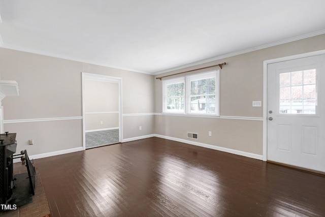 unfurnished living room featuring dark wood-type flooring, a healthy amount of sunlight, and crown molding