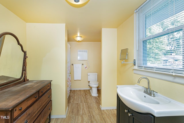 bathroom featuring hardwood / wood-style floors, vanity, and toilet