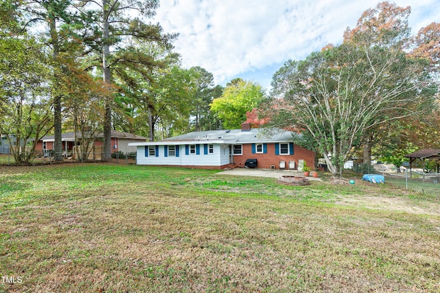 rear view of property with a patio area and a yard