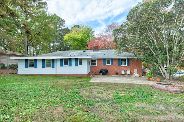 back of property with a lawn and a patio area