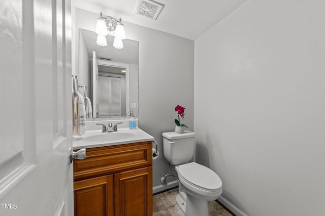 bathroom featuring vanity, a chandelier, toilet, and tile patterned flooring