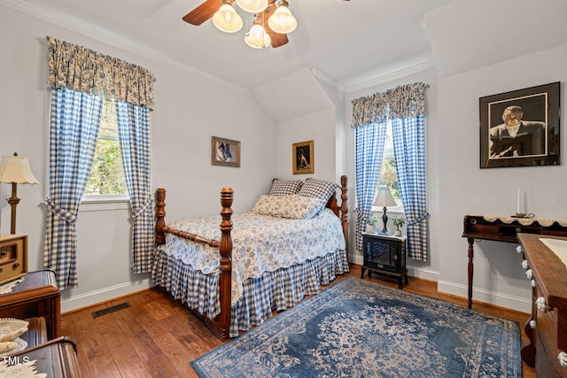 bedroom featuring ceiling fan, crown molding, and hardwood / wood-style floors