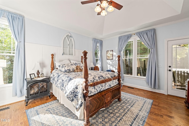 bedroom featuring hardwood / wood-style floors, multiple windows, and ceiling fan