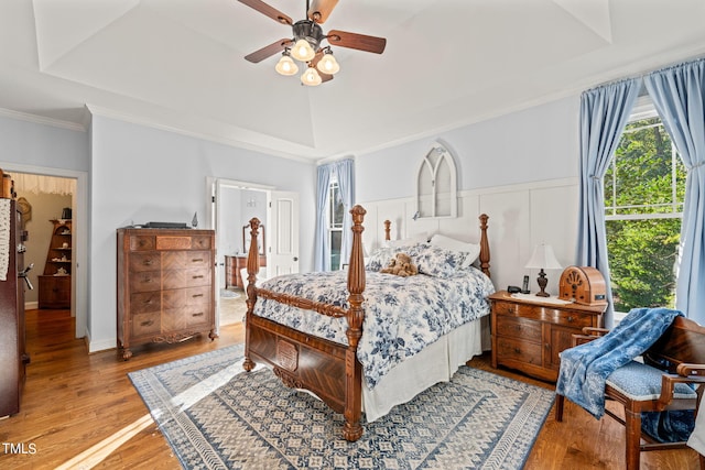 bedroom with ornamental molding, hardwood / wood-style flooring, and ceiling fan