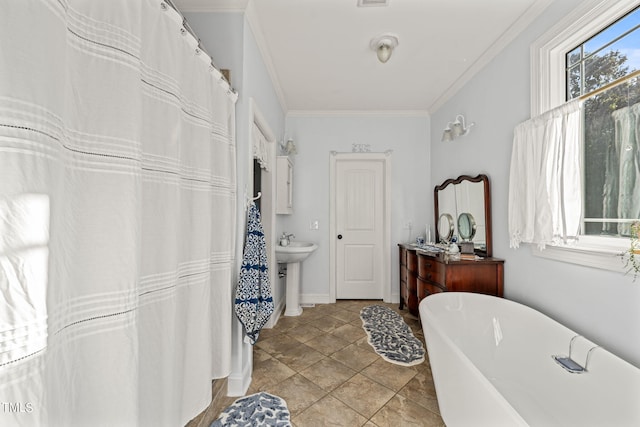 bathroom with crown molding, sink, tile patterned floors, and a washtub