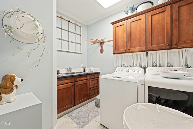 clothes washing area featuring light tile patterned floors, sink, separate washer and dryer, crown molding, and cabinets