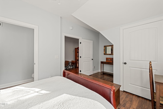 bedroom with dark hardwood / wood-style floors