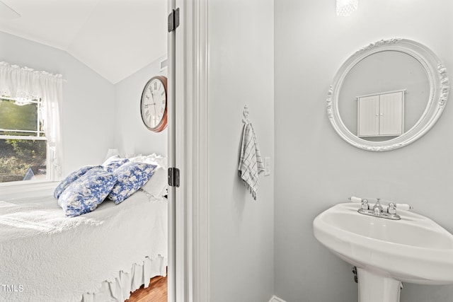 bathroom featuring sink and vaulted ceiling