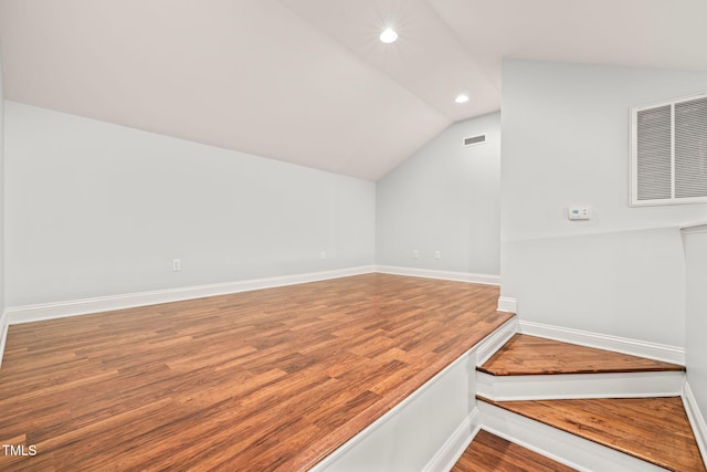 interior space with wood-type flooring and vaulted ceiling