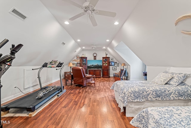 bedroom with ceiling fan, vaulted ceiling, and hardwood / wood-style floors