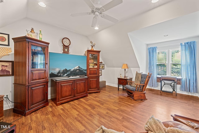 sitting room with lofted ceiling, hardwood / wood-style floors, and ceiling fan