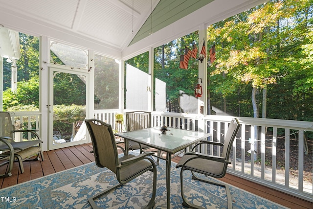 sunroom / solarium featuring lofted ceiling