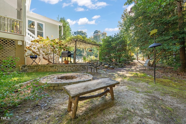 view of yard featuring a patio and an outdoor fire pit