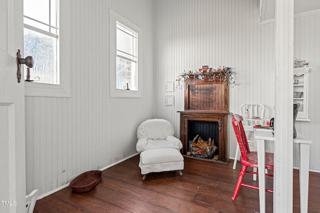 sitting room with a wealth of natural light and hardwood / wood-style flooring