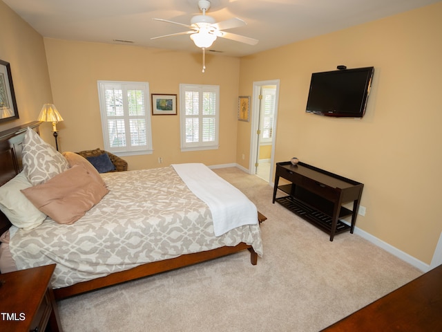bedroom featuring light colored carpet and ceiling fan