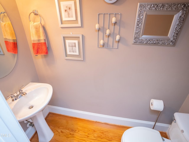 bathroom featuring toilet and hardwood / wood-style floors
