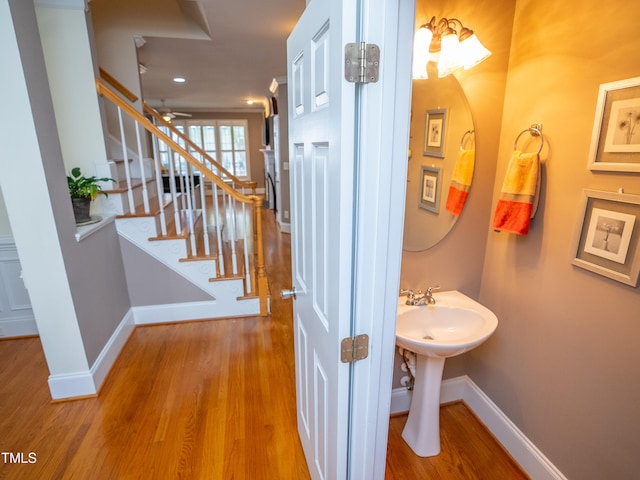 bathroom with wood-type flooring and ceiling fan