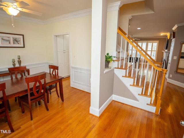 dining room featuring light hardwood / wood-style flooring, ceiling fan, and crown molding