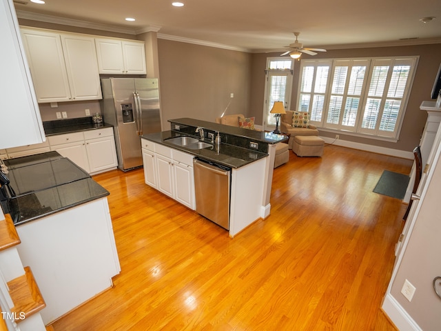 kitchen featuring white cabinetry, appliances with stainless steel finishes, sink, and light hardwood / wood-style floors