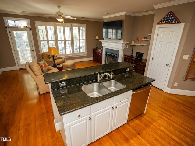 kitchen featuring dark stone counters, light hardwood / wood-style floors, white cabinets, dishwasher, and ceiling fan