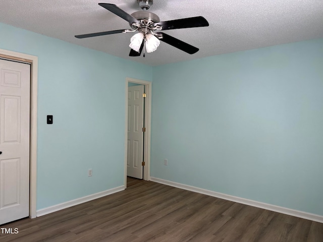 unfurnished bedroom with a textured ceiling, dark wood-type flooring, and ceiling fan