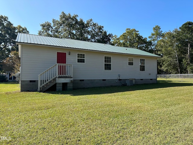 back of house with a lawn