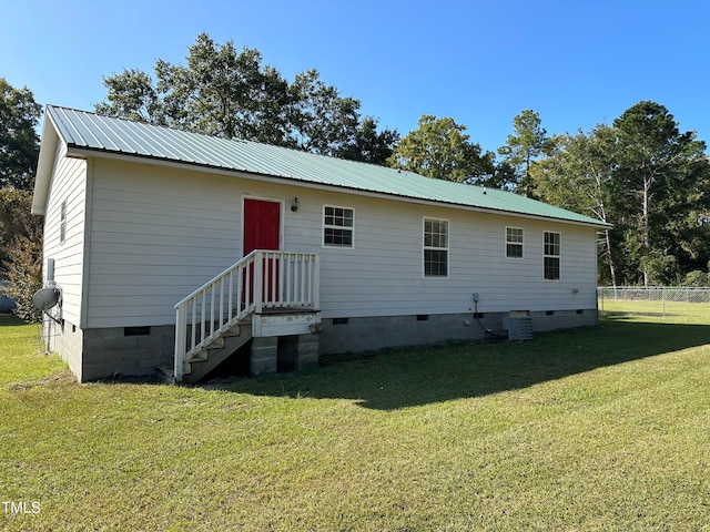 rear view of property featuring a yard